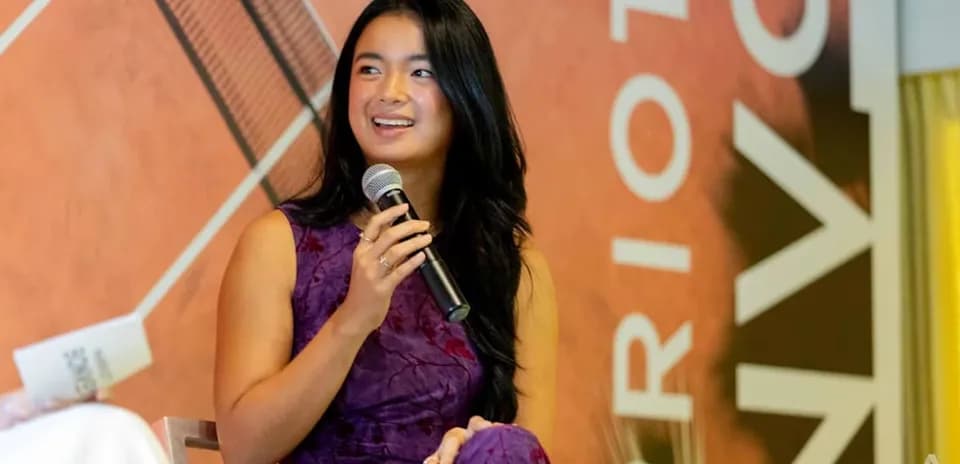 Young woman speaking into a microphone at event
