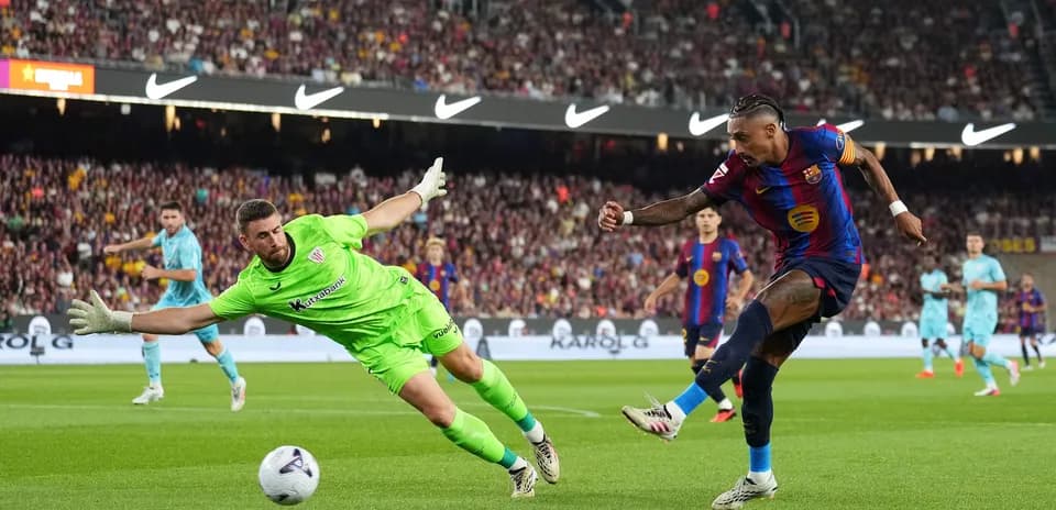 Player shooting at goal while goalkeeper dives