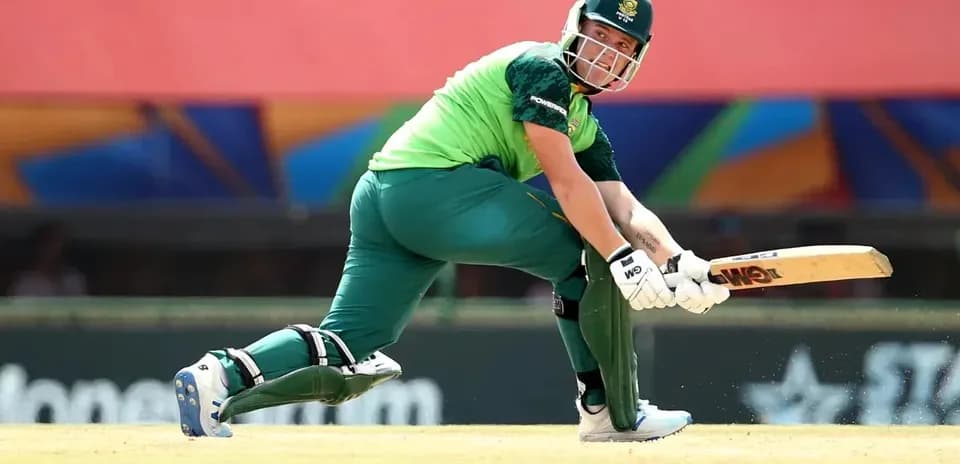 Batsman playing a shot on cricket field