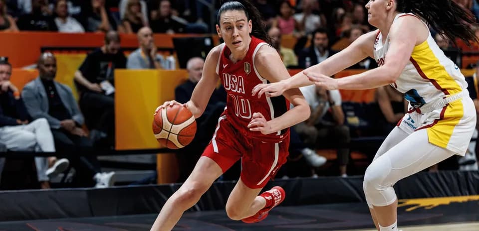 USA player dribbling past defender during game