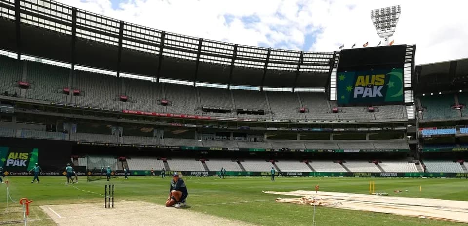 Players warming up at cricket ground before match