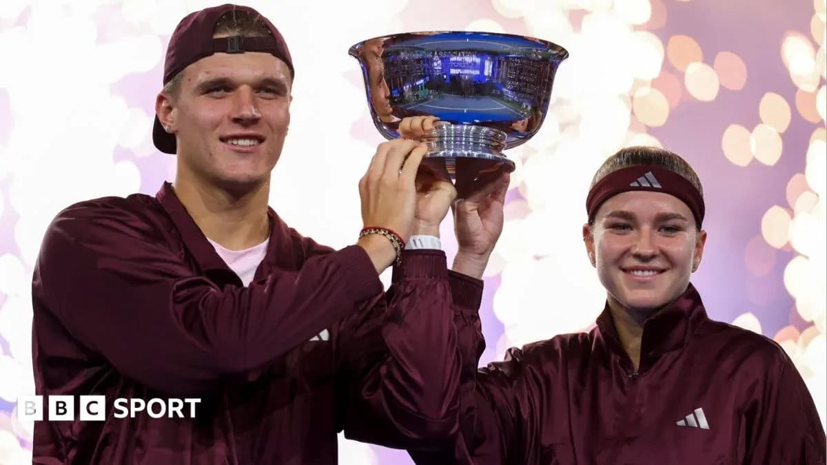 Players celebrating victory with trophy on stage