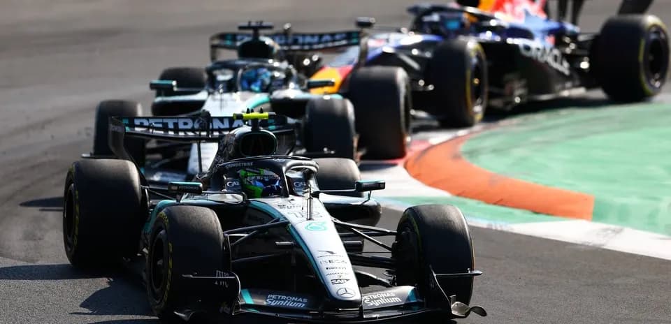 Two Formula 1 cars racing on a track