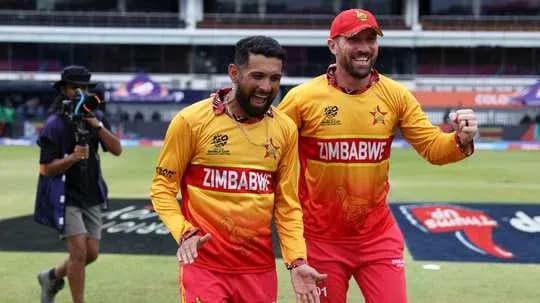 Two Zimbabwean cricketers celebrating on the field