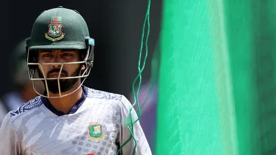 Cricketer in helmet walking towards practice net