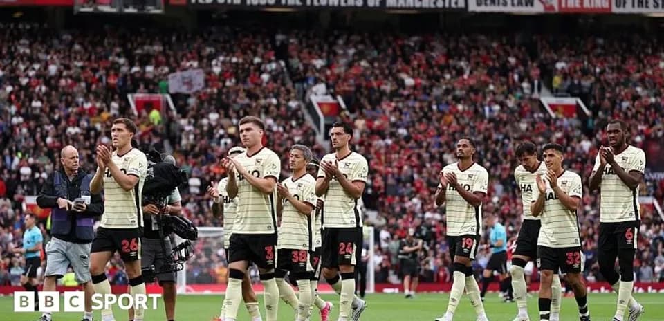 Players applauding fans after a match at stadium