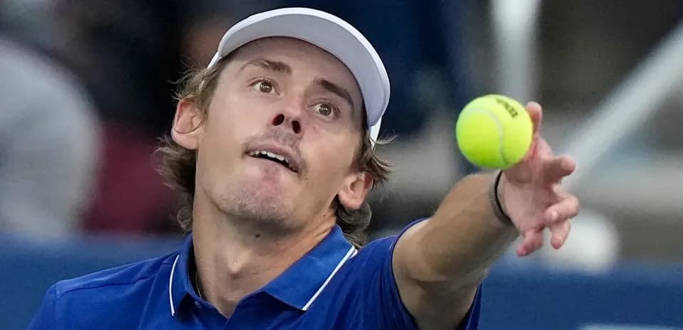 Player serving a tennis ball during match