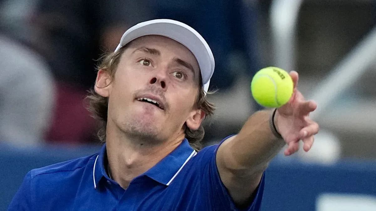 Player serving a tennis ball during match