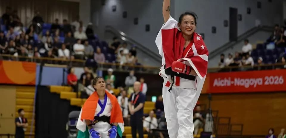 Winning martial artist celebrating with raised arm