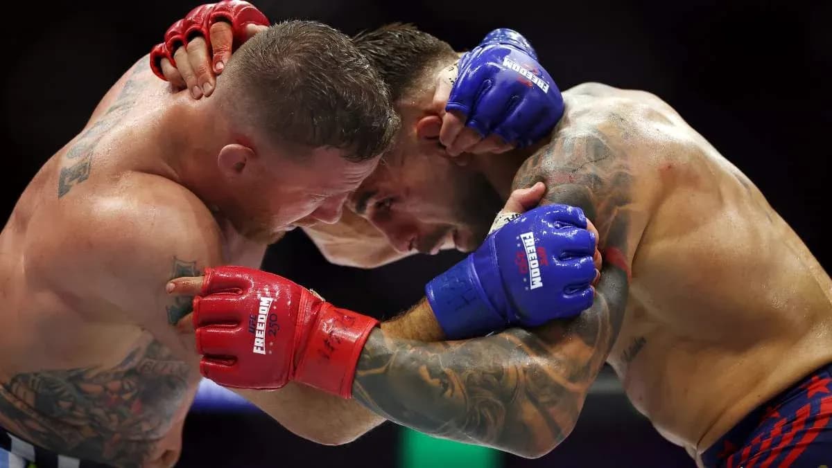 Two fighters clinching in a boxing match