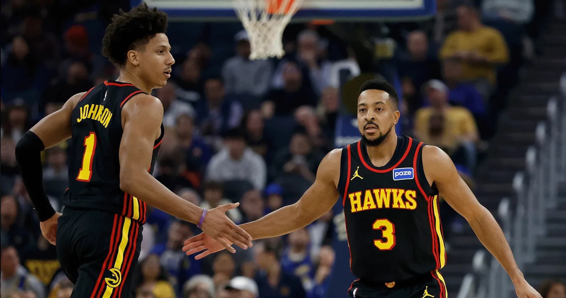 Two Atlanta Hawks players celebrating a play