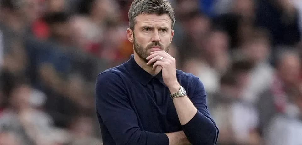 Coach pondering during match with spectators in background