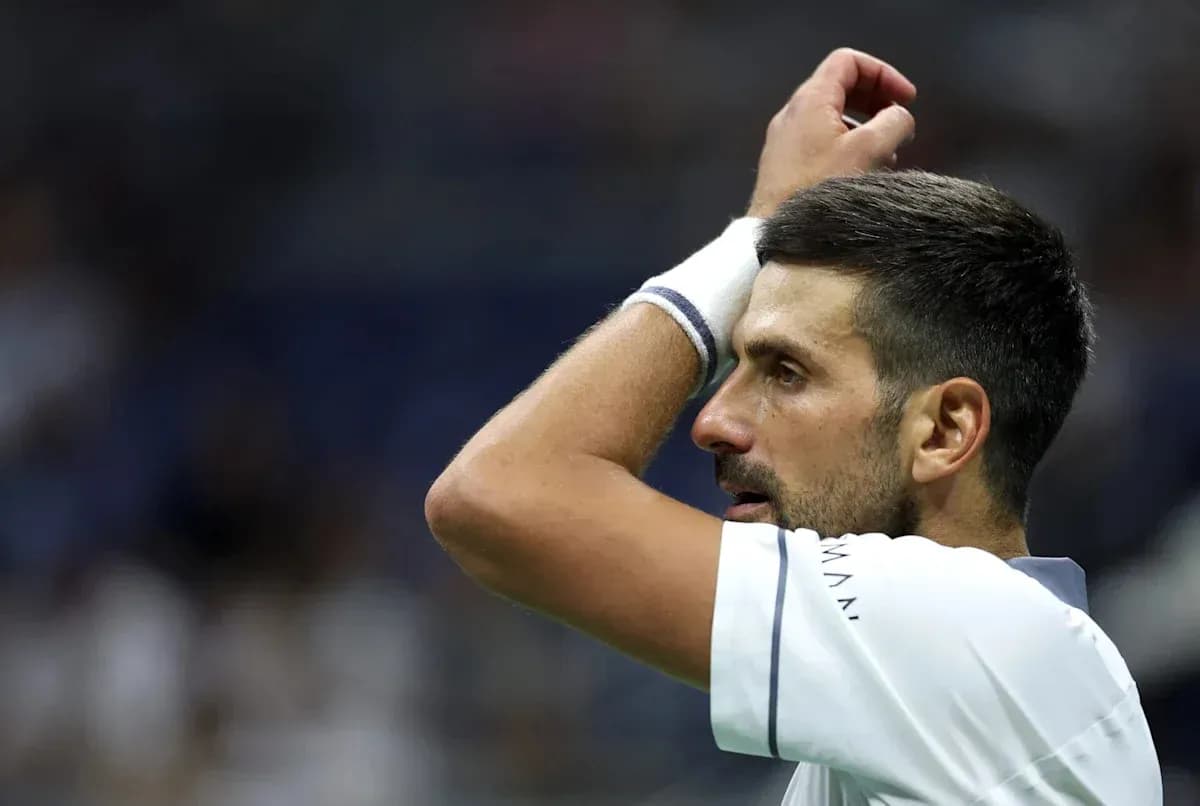 Tennis player adjusting headband during match