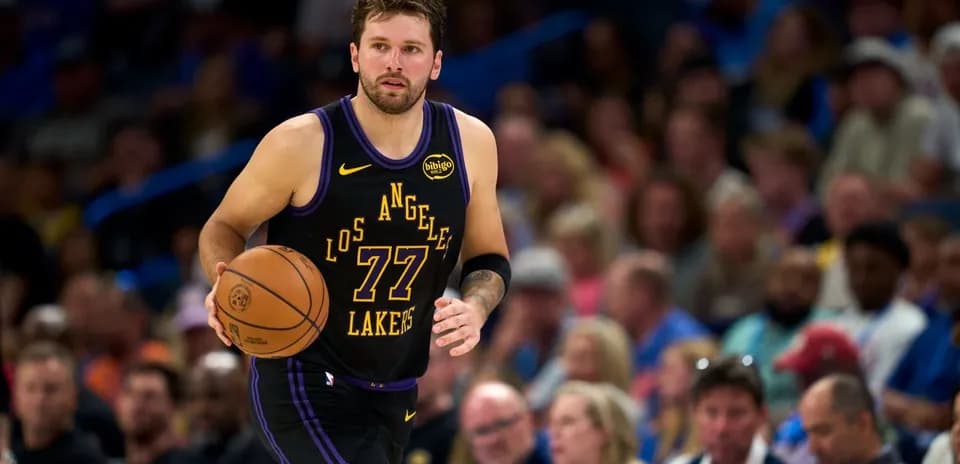 Player dribbling basketball during game with crowd