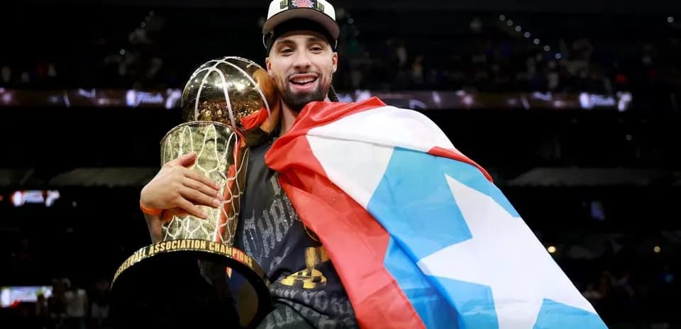 Player celebrating with championship trophy and flag
