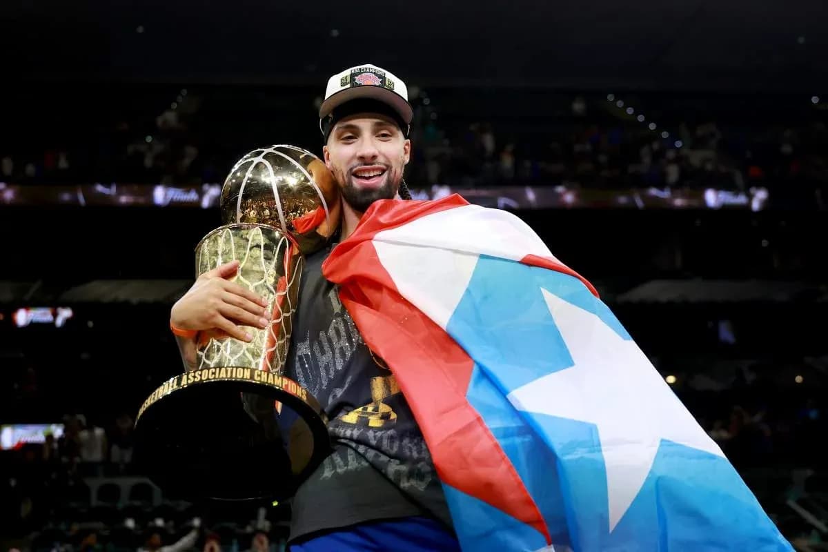 Player celebrating with championship trophy and flag