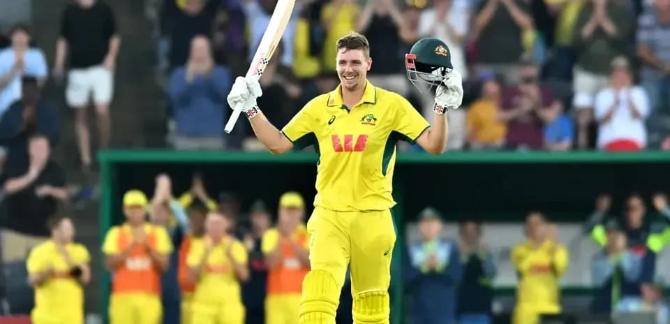 Cricketer celebrating century with bat raised