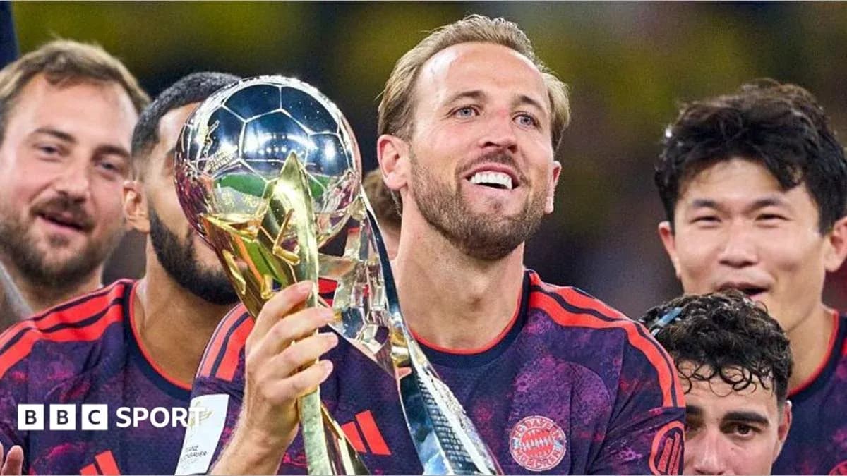 Player celebrating with trophy and teammates