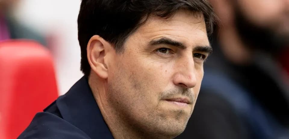 Coach observing from the sidelines during a match