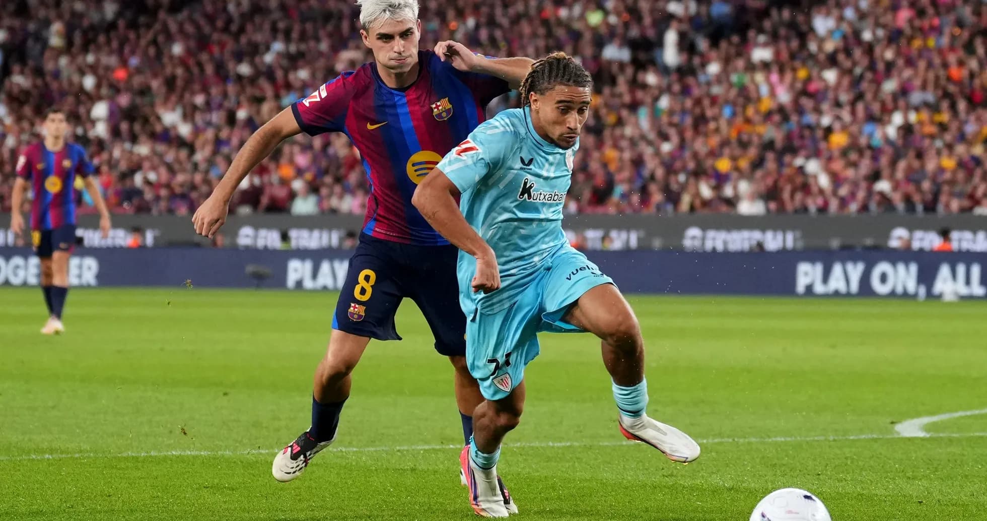 Player from FC Barcelona challenging opponent for the ball