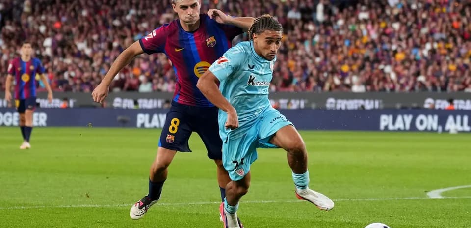 Player from FC Barcelona challenging opponent for the ball