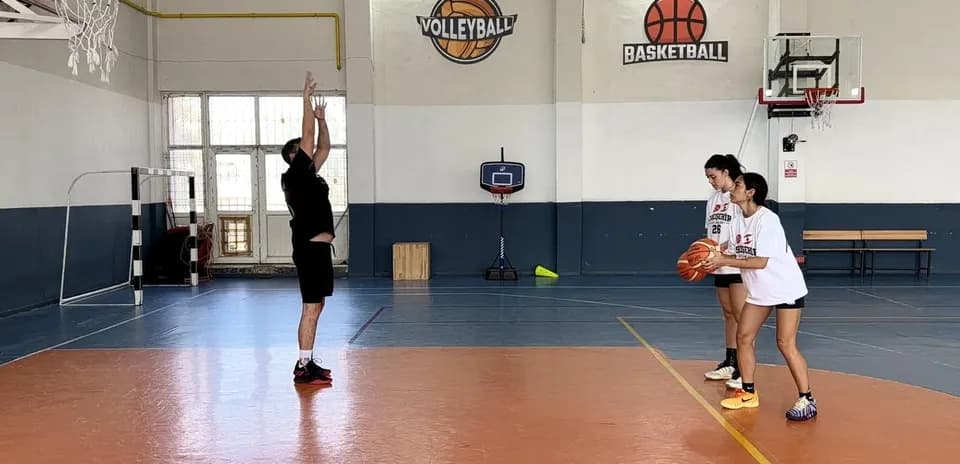 Coach instructing players during basketball practice
