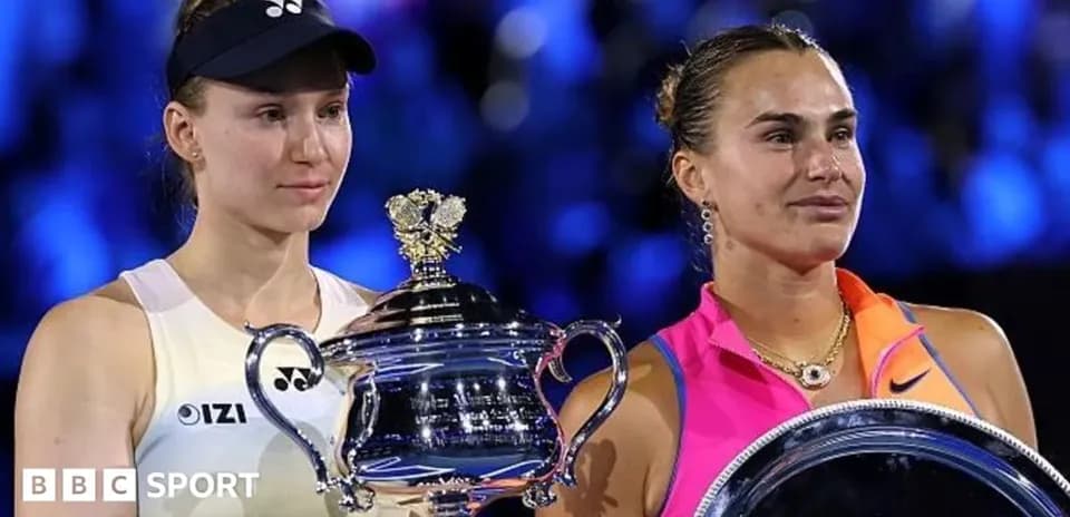 Two tennis players holding trophies after match