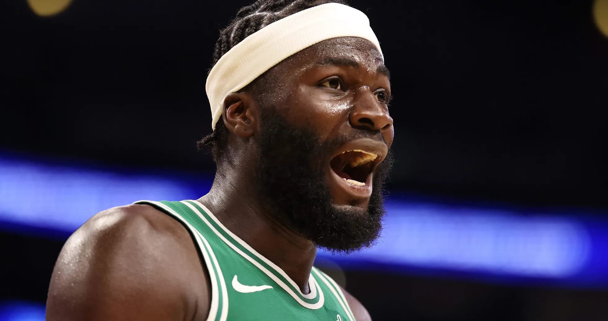 Player in green jersey reacting during basketball game