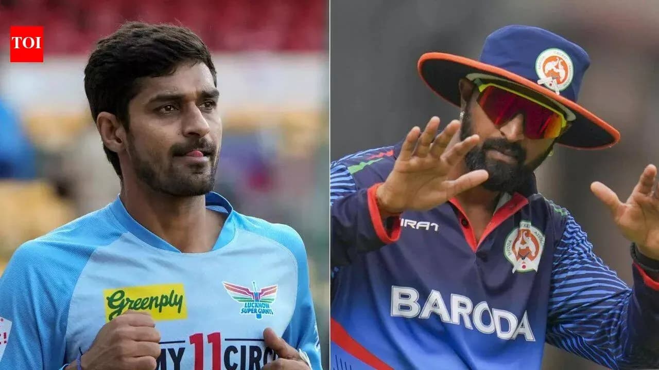 Two cricket players in team uniforms during match