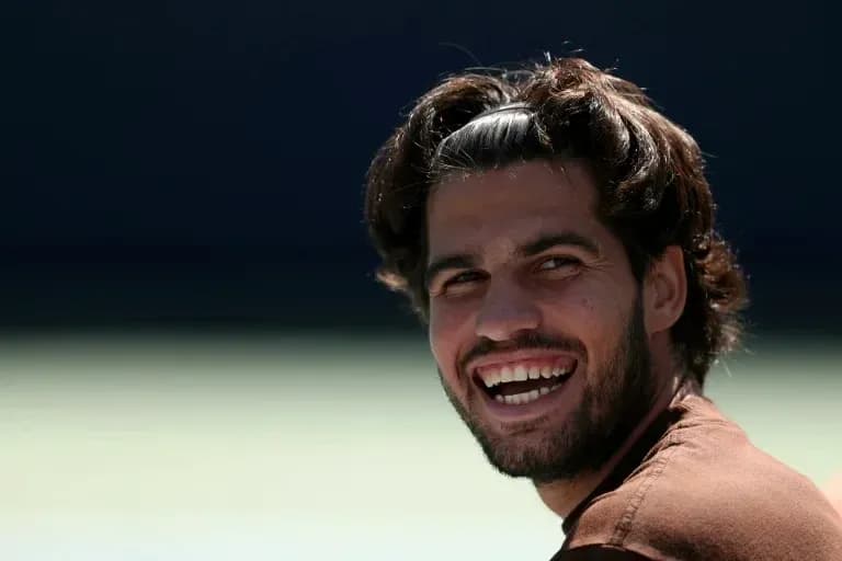 Tennis player smiling during practice session