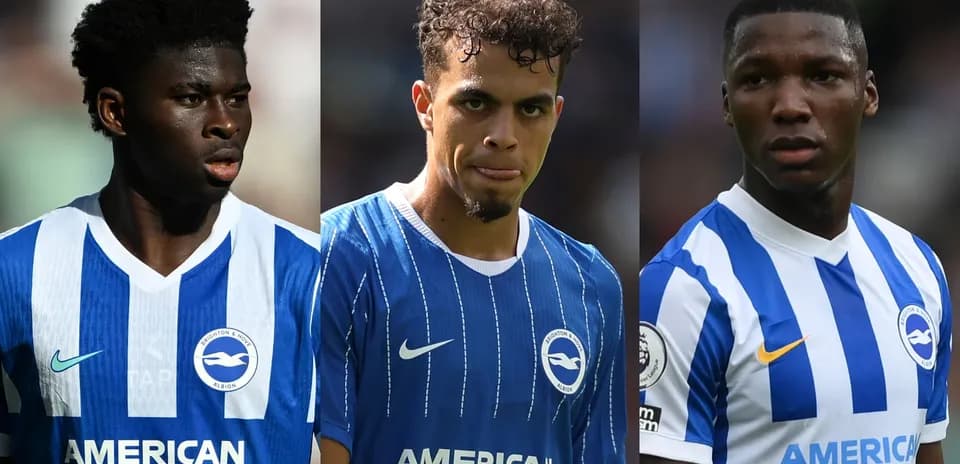 Three Brighton players in team jerseys on field