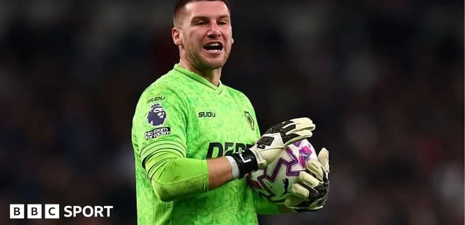 Goalkeeper in green kit holding soccer ball