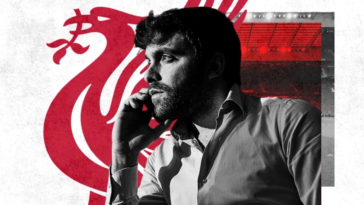 Man on phone with Liverpool logo background