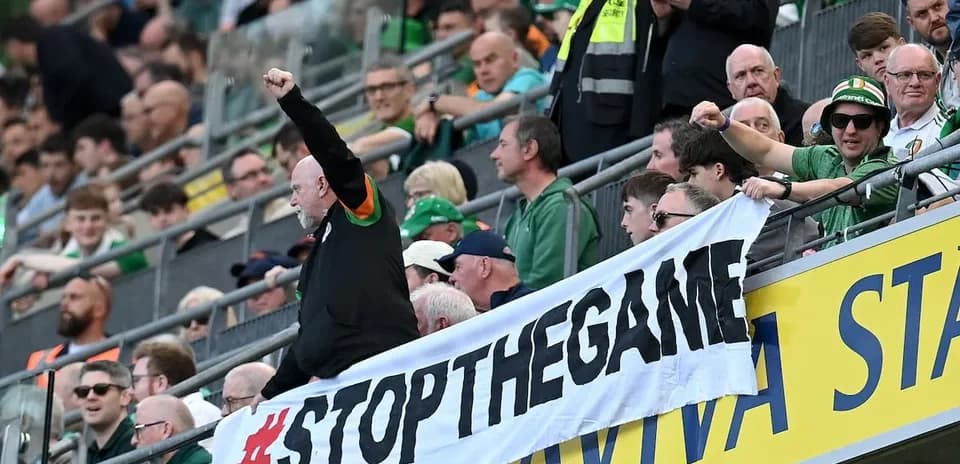 Fans holding a banner at a sports event