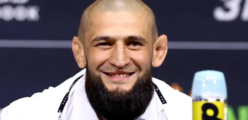 Fighter smiling at press conference with microphone