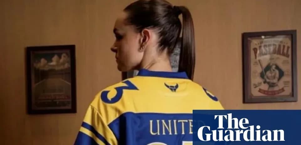 Person wearing a yellow sports jersey with 'UNITED' on back