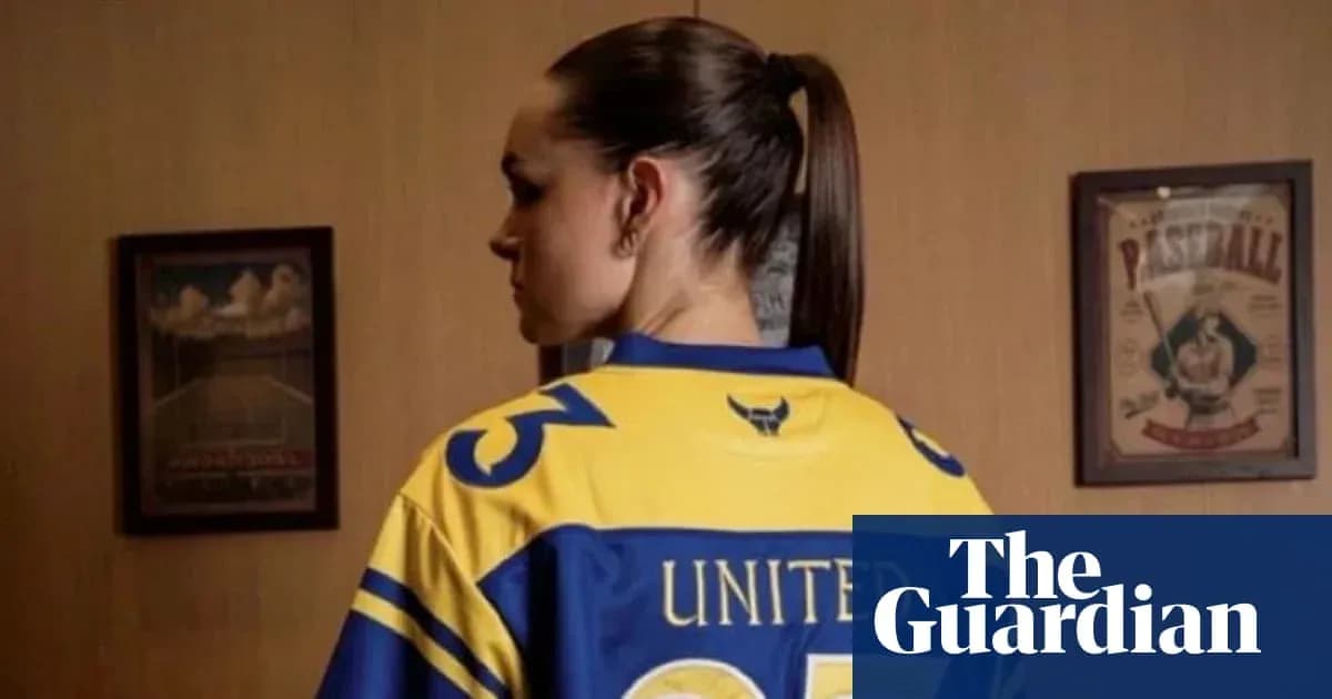 Person wearing a yellow sports jersey with 'UNITED' on back
