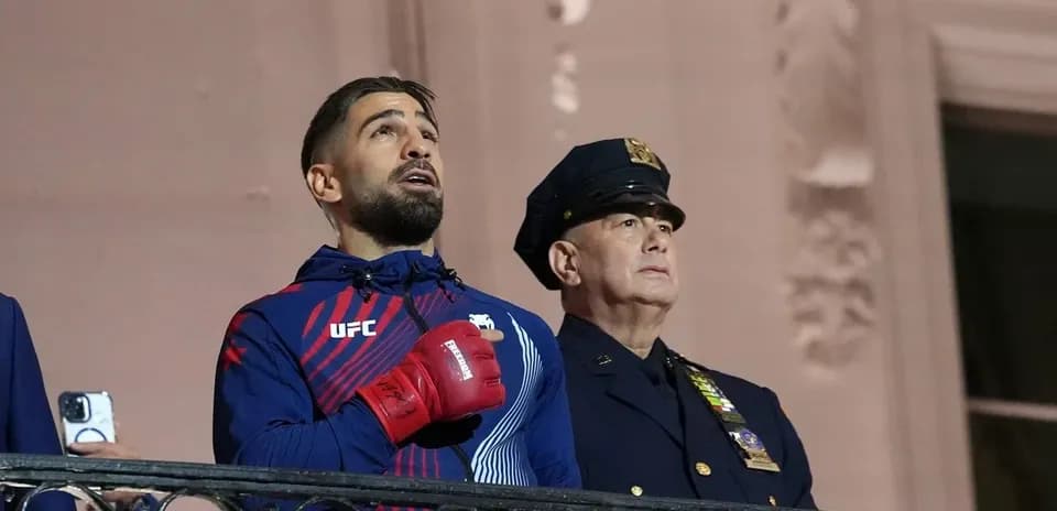 UFC fighter singing anthem with police officer nearby