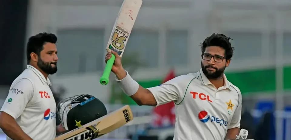 Two cricketers celebrating a milestone on field