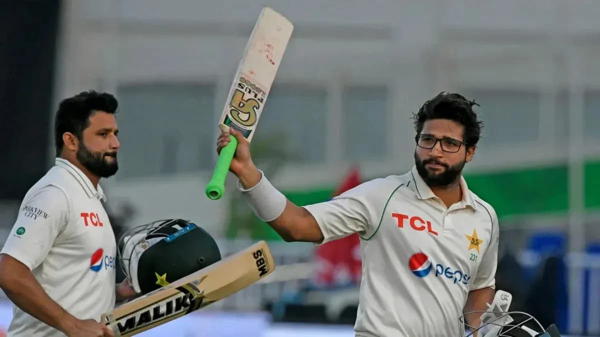 Two cricketers celebrating a milestone on field