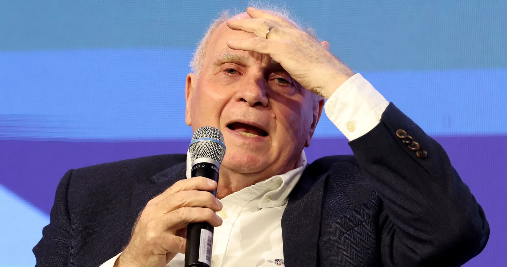 Man speaking into microphone at event