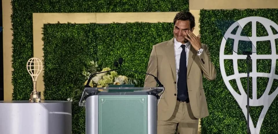 Roger Federer speaking at an award ceremony podium