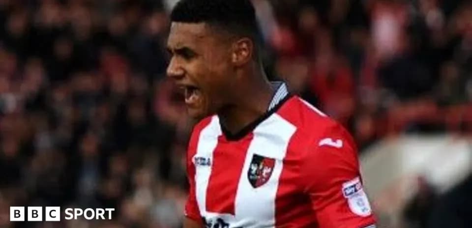 Player celebrating in Exeter City jersey during match