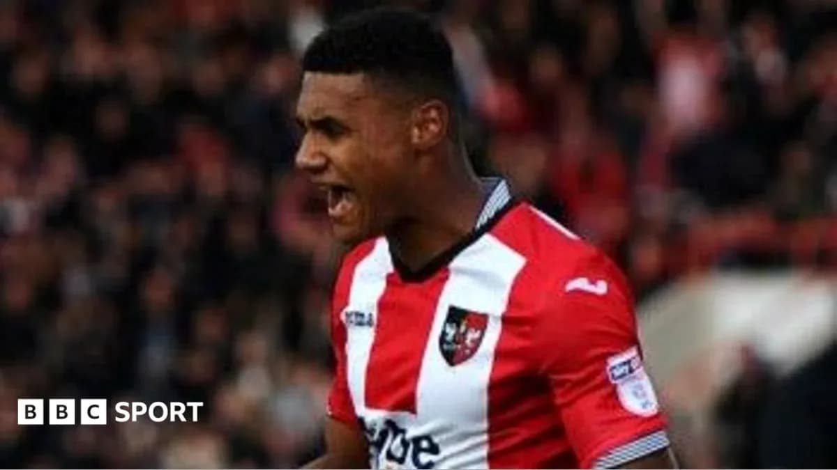 Player celebrating in Exeter City jersey during match