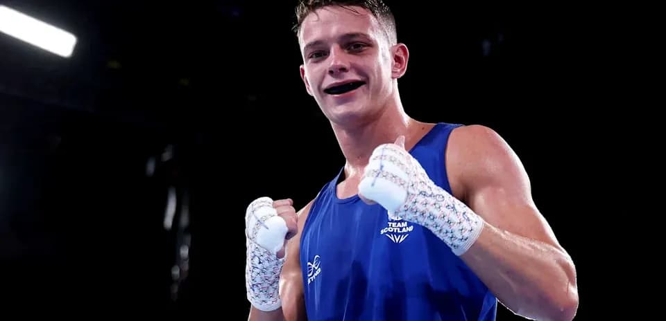 Boxer from Team Scotland celebrating victory in the ring