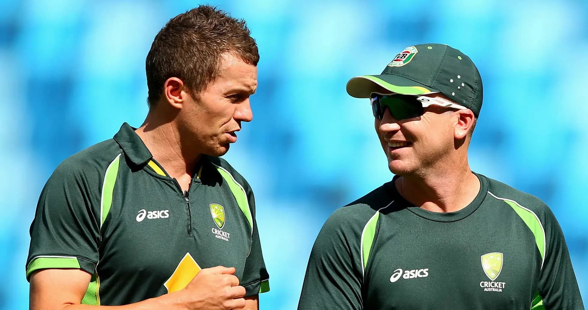 Two cricketers talking during a practice session
