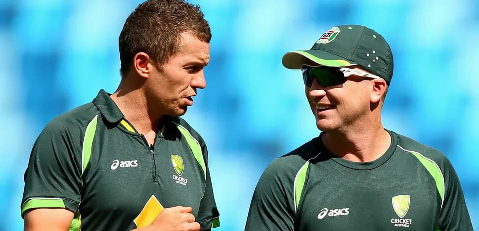 Two cricketers talking during a practice session