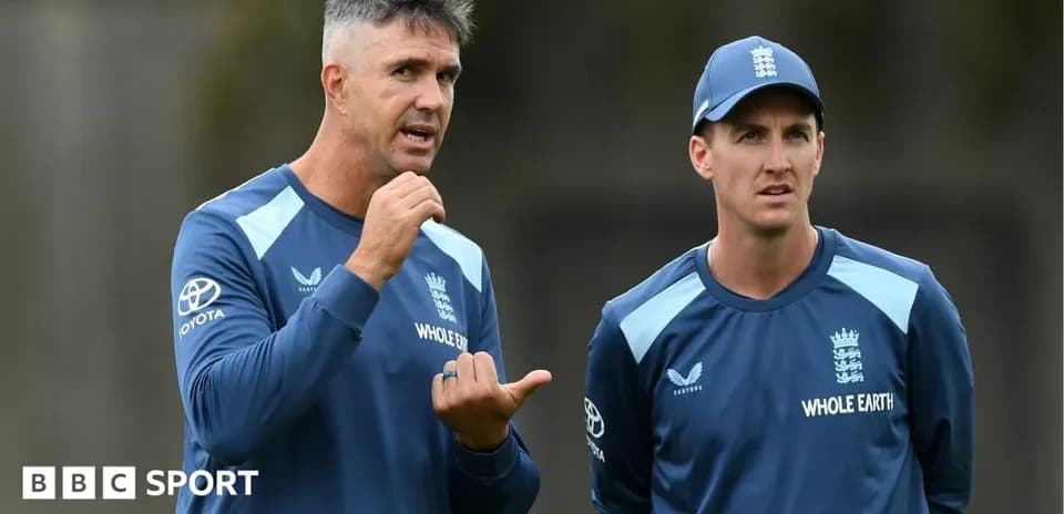 Two coaches discussing strategy during training session