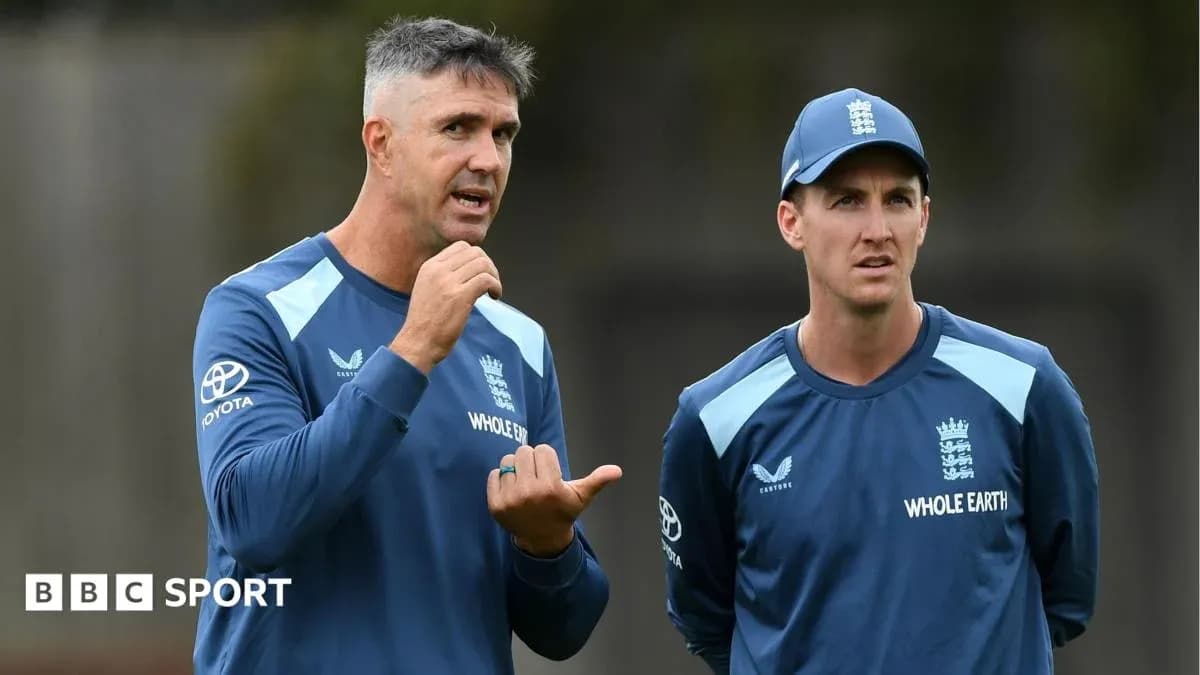 Two coaches discussing strategy during training session