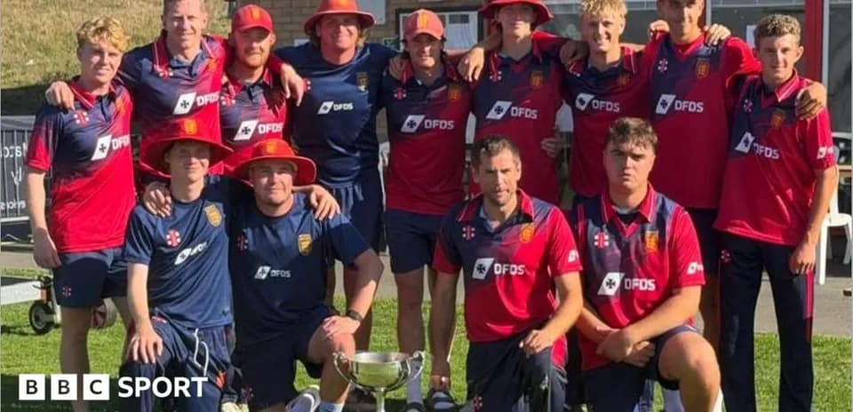 Cricket team posing with trophy in summer sun